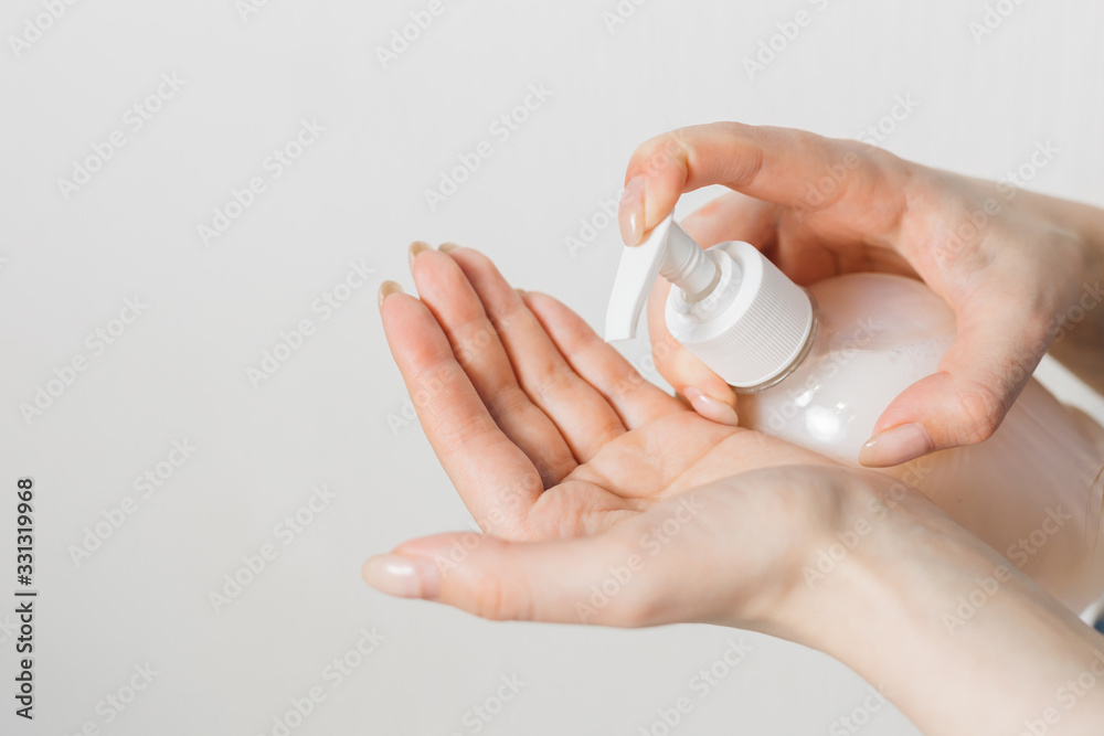 girl squeezes liquid soap on her hand. quarantine. prevention of coronavirus. scientist in biological protective Epidemic virus outbreak concept. COVID-19 girl squeezes liquid soap on her hand. quarantine. prevention of coronavirus. scientist in biological protective Epidemic virus outbreak concept. COVID-19