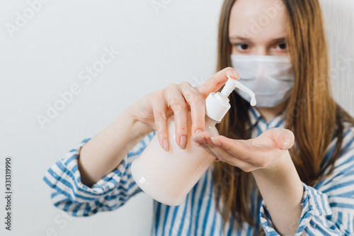 girl squeezes liquid soap on her hand. quarantine. prevention of coronavirus. scientist in biological protective Epidemic virus outbreak concept. COVID-19