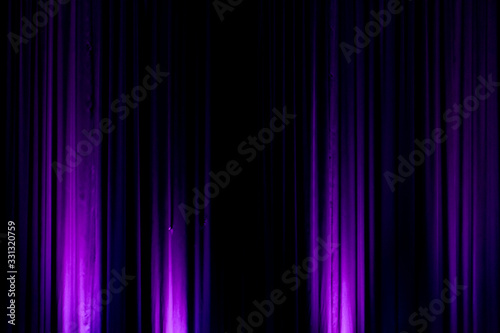 Black backdrop with purple lights in a city theater