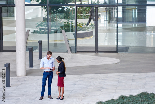 Diverse businesspeople using a tablet outside of an office