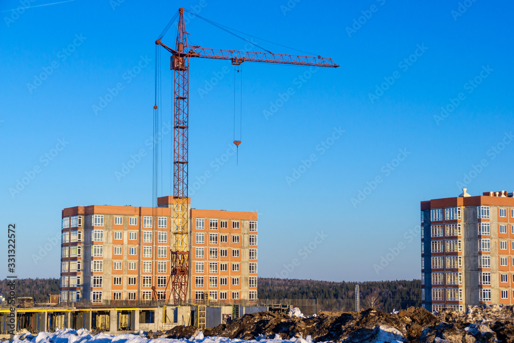 erection of a frame of a monolithic building using a construction tower crane