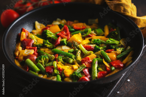 Fried vegetables with sauce on pan