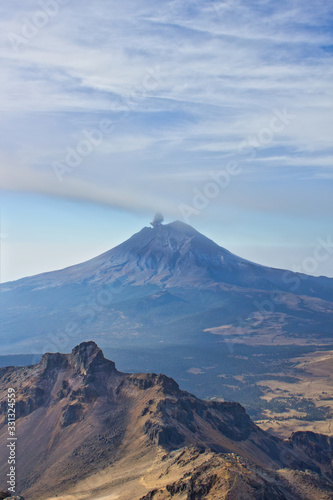Climbing the Iztaccihuatl volcano, Popocatepetl volcano in Mexico, Tourist on the peak of high rocks. Sport and active life concept
