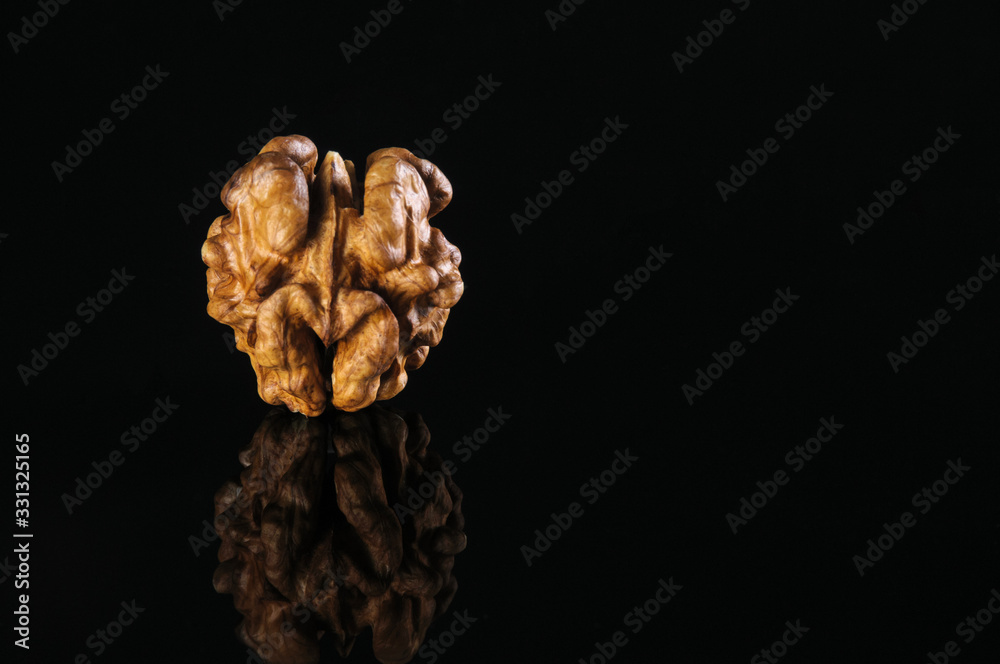 Fototapeta premium Walnut kernel on a black table