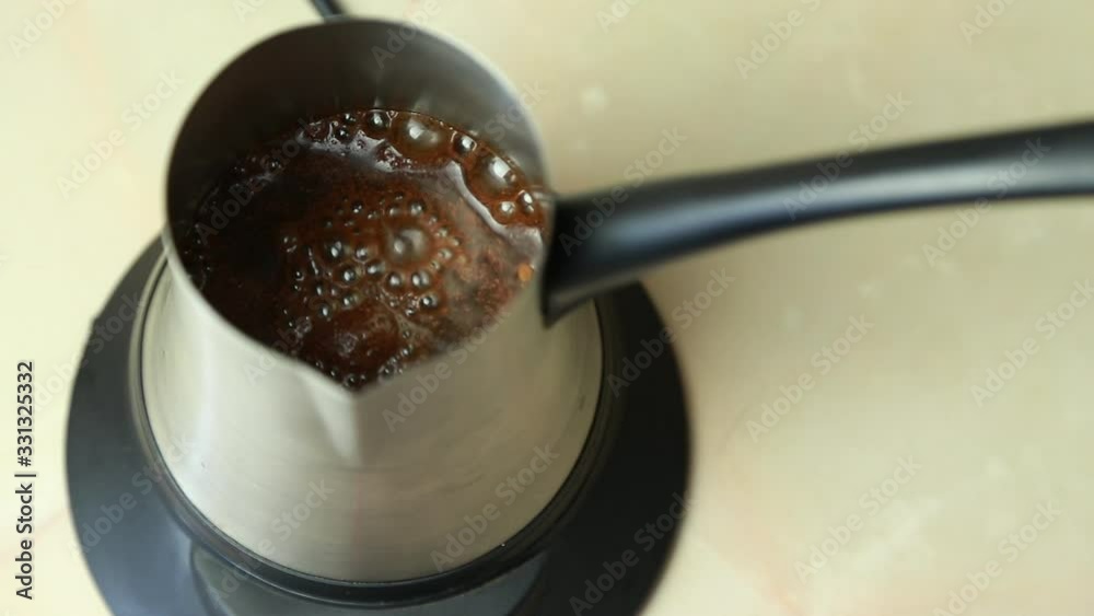 Making turkish coffee in electric cezve. Adding water Making turkish coffee in electric cezve. Adding water