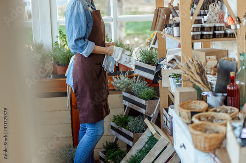 Foto Woman herbalist standing near a shelf wooden rack
