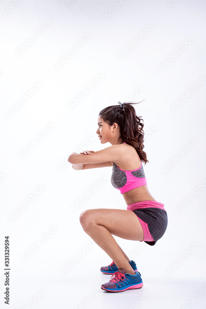 The beautiful lady wearing sportwear,kneel and rasie hand up in front of chest,warm up and stretching muscle,before exercise The beautiful lady wearing sportwear,kneel and rasie hand up in front of chest,warm up and stretching muscle,before exercise