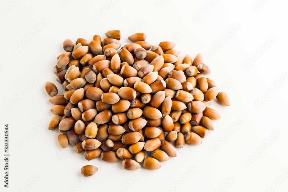 Ripe,new crop hazelnuts heap on white background with copy space,top view Ripe,new crop hazelnuts heap on white background with copy space,top view