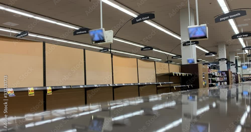 Empty shelves in the toilet paper and paper towel aisle at a grocery store in Chicago Illinois during the COVID-19 coronavirus social distancing experience to flatten the curve.