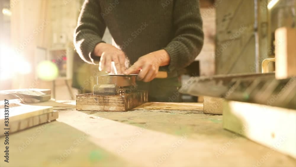 Bladesmith grinding a knife on grindstone Bladesmith grinding a knife on grindstone