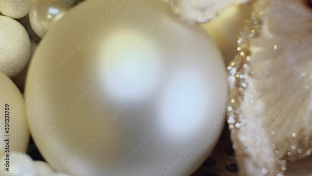Christmas composition consisting of baubles and flowers. 4K resolution close up shot, pedestal movement. Christmas composition consisting of baubles and flowers. 4K resolution close up shot, pedestal movement.