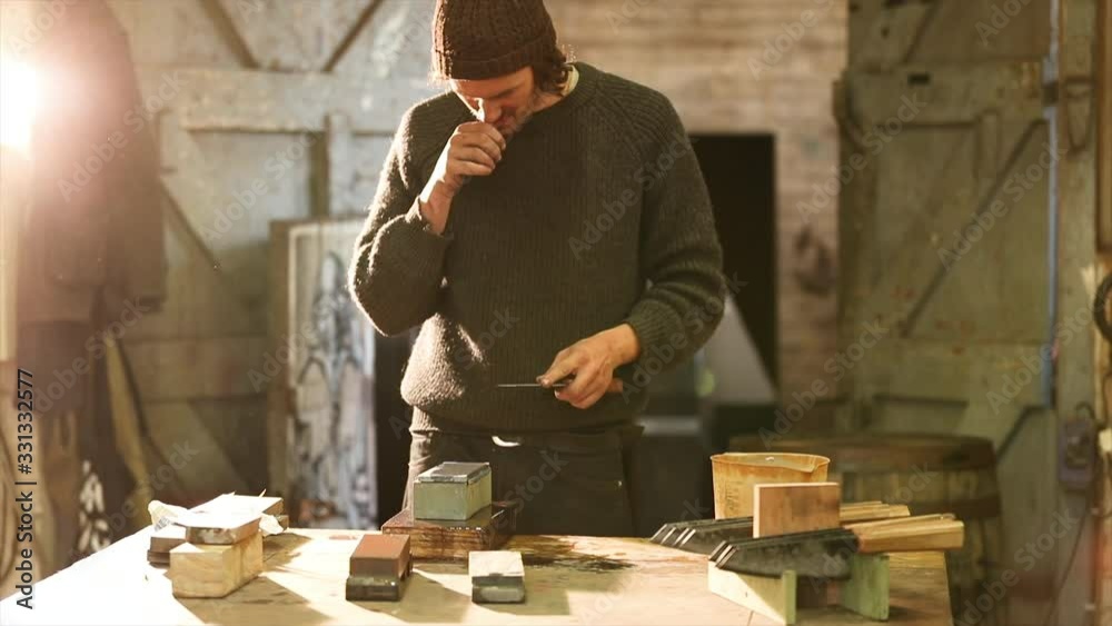 Bladesmith grinding a knife on grindstone