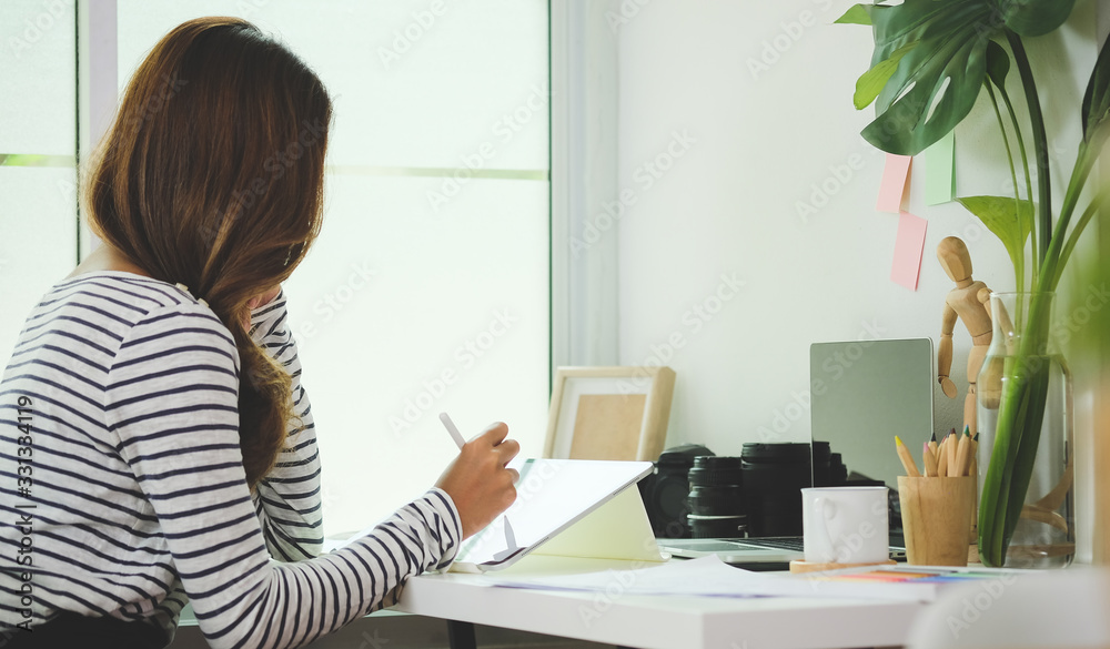 Business woman working in home living room enjoying sunny morning on the day with documents and laptop people Consulting and business planning. Business woman working in home living room enjoying sunny morning on the day with documents and laptop people Consulting and business planning.