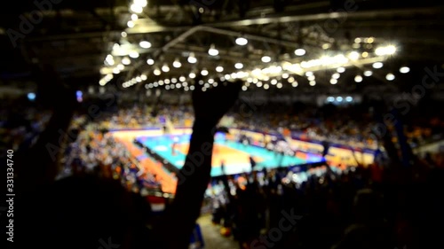 Blurry video of cheering team enjoy in volleyball game in indoor stadium