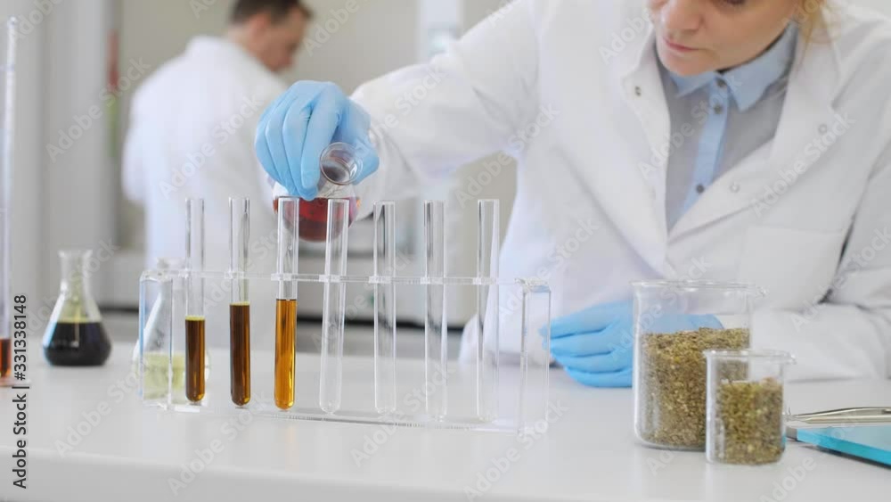 Close up of scientists working with CBD oil Close up of scientists working with CBD oil