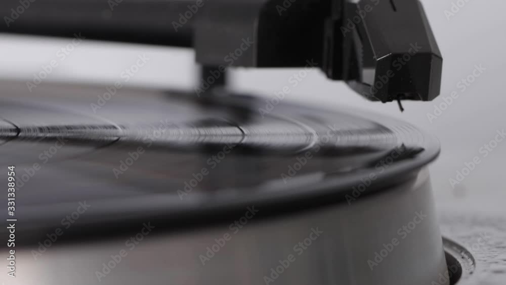Close up of turntable needle on a vinyl record. Turntable playing vinyl. Needle on rotating black vinyl. Close up of turntable needle on a vinyl record. Turntable playing vinyl. Needle on rotating black vinyl.