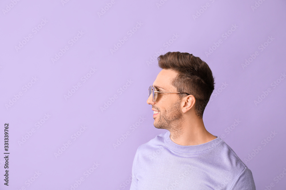 Young man with stylish sunglasses on color background Young man with stylish sunglasses on color background