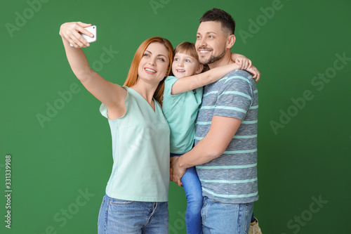 Family taking selfie on col...
