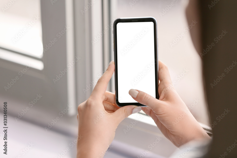 Young woman with mobile phone at home Young woman with mobile phone at home