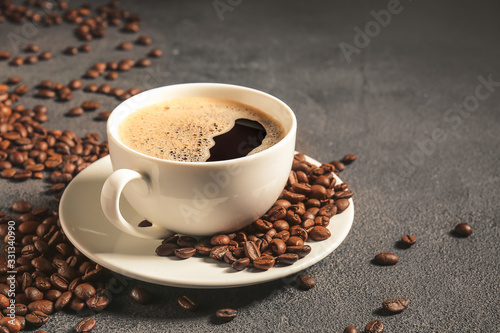 Cup of hot coffee and beans on table © Pixel-Shot