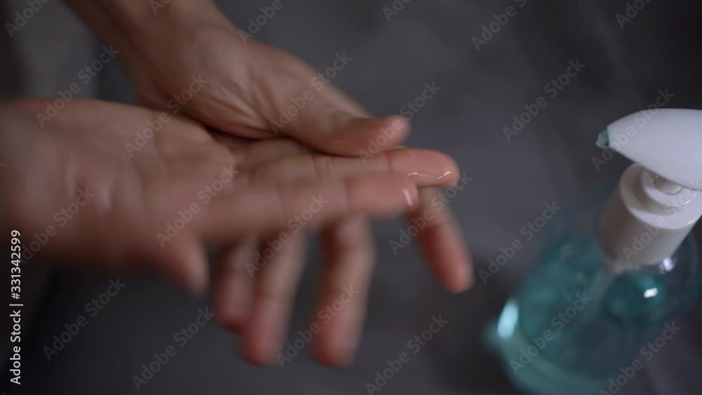 4k woman hand apply hand sanitizer gel to prevent bacteria, Coronavirus 2019, covid19, at home self prevention, killing germs, hand washing, hand blue alcohol gel, gray sofa background, 4k woman hand apply hand sanitizer gel to prevent bacteria, Coronavirus 2019, covid19, at home self prevention, killing germs, hand washing, hand blue alcohol gel, gray sofa background,