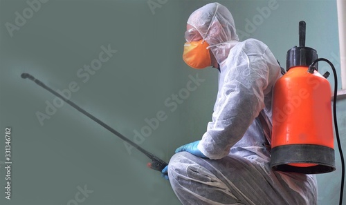Cleaning and Disinfection in public areas amid the coronavirus epidemic. Spraying of disinfectants. Infection prevention and control of epidemic. Protective suit and mask
