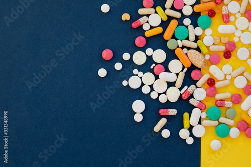 Composition with nutritional supplement capsules. Variety of pharmaceutical capsule.Vitamins for care, medication, treatment.colorful pills for diseases, narcotic drugs on colorful background.