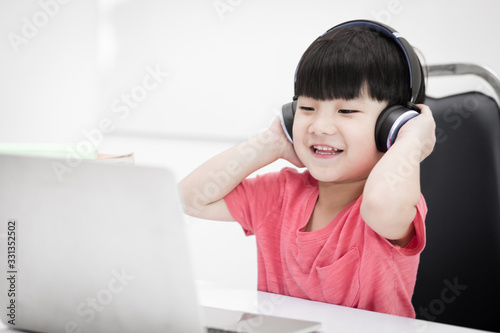 Cute Asian students are happy to study on a notebook. And having fun, smiling, laughing in education