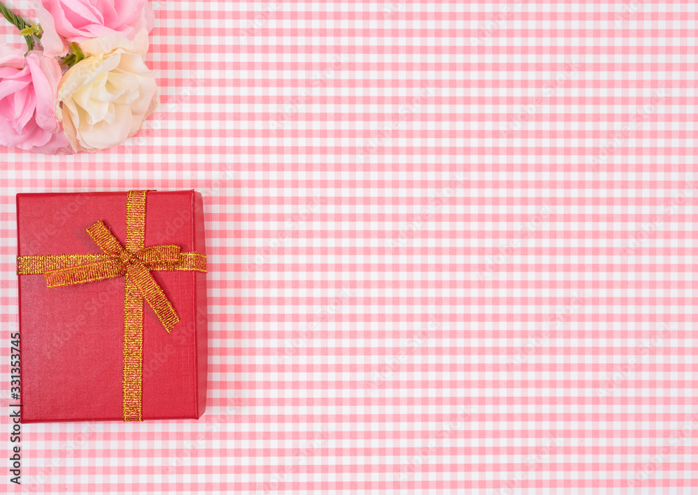 gift box with red isolated on Plaid background. Holiday decoration for Mother's Day or Women's Day.