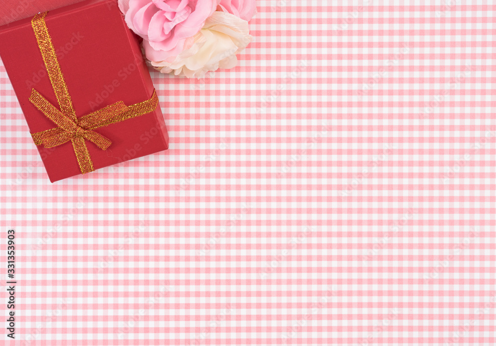 gift box with red isolated on Plaid background. Holiday decoration for Mother's Day or Women's Day. gift box with red isolated on Plaid background. Holiday decoration for Mother's Day or Women's Day.