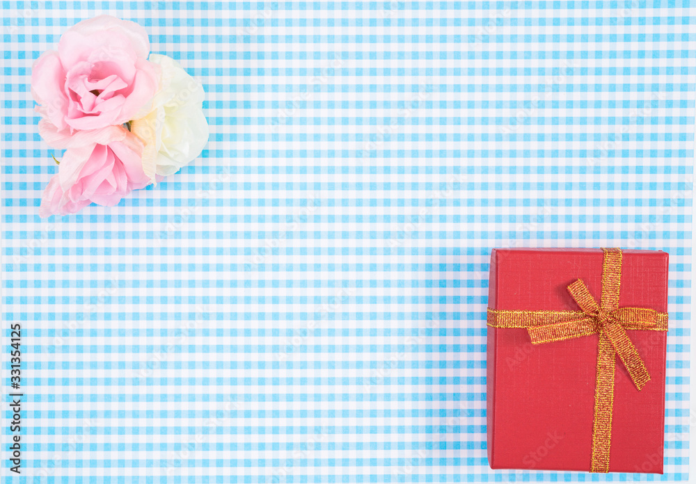 gift box with red isolated on Plaid background. Holiday decoration for Mother's Day or Women's Day. gift box with red isolated on Plaid background. Holiday decoration for Mother's Day or Women's Day.