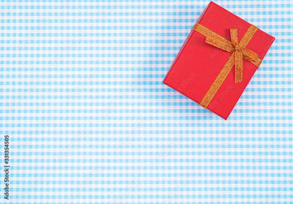 gift box with red isolated on Plaid background. Holiday decoration for Mother's Day or Women's Day.