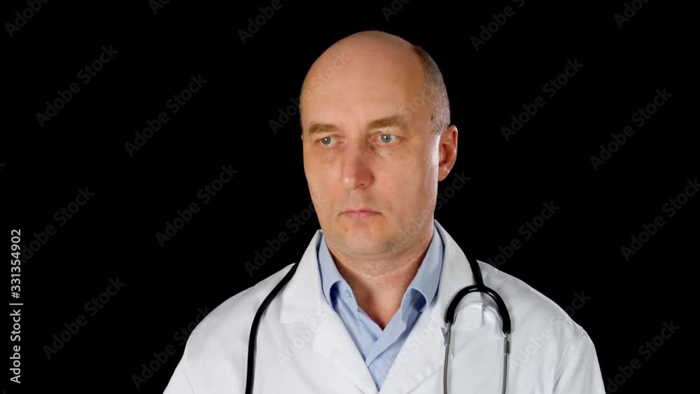 Concentrated doctor swiping slide browse virtual screen with fingers. Front view of focused doctor using imaginary screen on black background. Virtual screen concept Concentrated doctor swiping slide browse virtual screen with fingers. Front view of focused doctor using imaginary screen on black background. Virtual screen concept