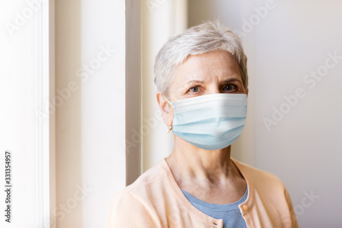 health, safety and pandemic concept - senior woman wearing protective medical mask for protection from virus