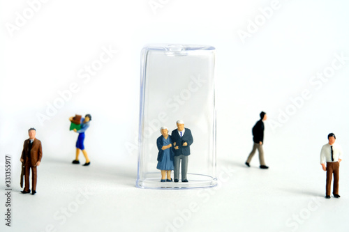 Pandemic corona virus conceptual miniature people photography – social distancing strategy - middle-aged figure on tube isolation photo