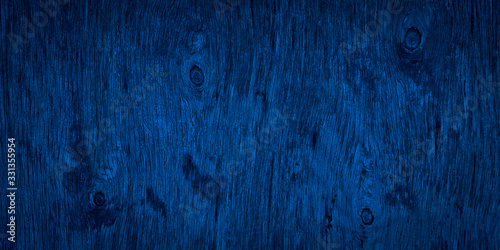 The texture of navy blue wood. Texture of old dried plywood. Classic blue background for design.