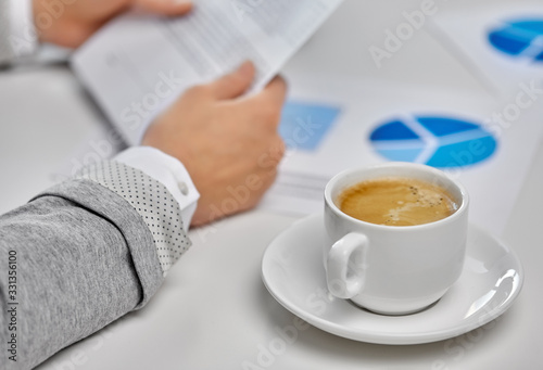 business  drink and people concept - hands of businesswoman and cup of coffee at office