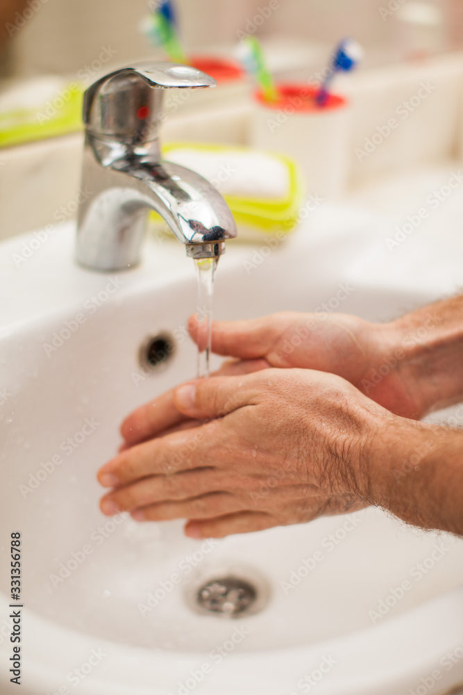 Man washing hands with soap in bathroom. People and healthcare concept. Man washing hands with soap in bathroom. People and healthcare concept.