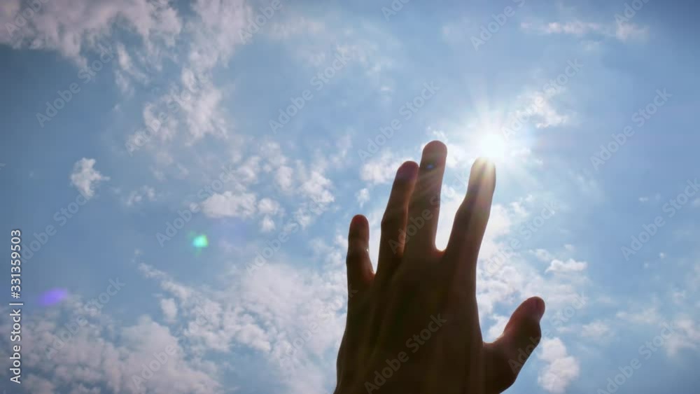 Silhouette hand of man reach to sun and deep blue sky. Conceptual scene Silhouette hand of man reach to sun and deep blue sky. Conceptual scene