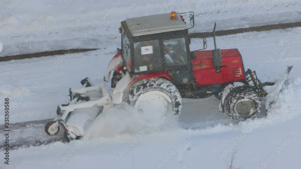 Tractor removing snow from walkways