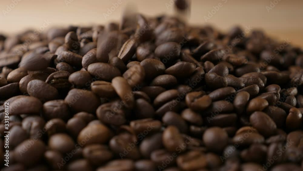 Coffee beans falling on a table in slow motion Coffee beans falling on a table in slow motion