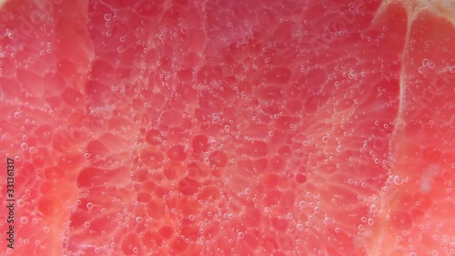 grapefruit piece into water. selective focus juicy ripe fruit in water close-up, macro photo