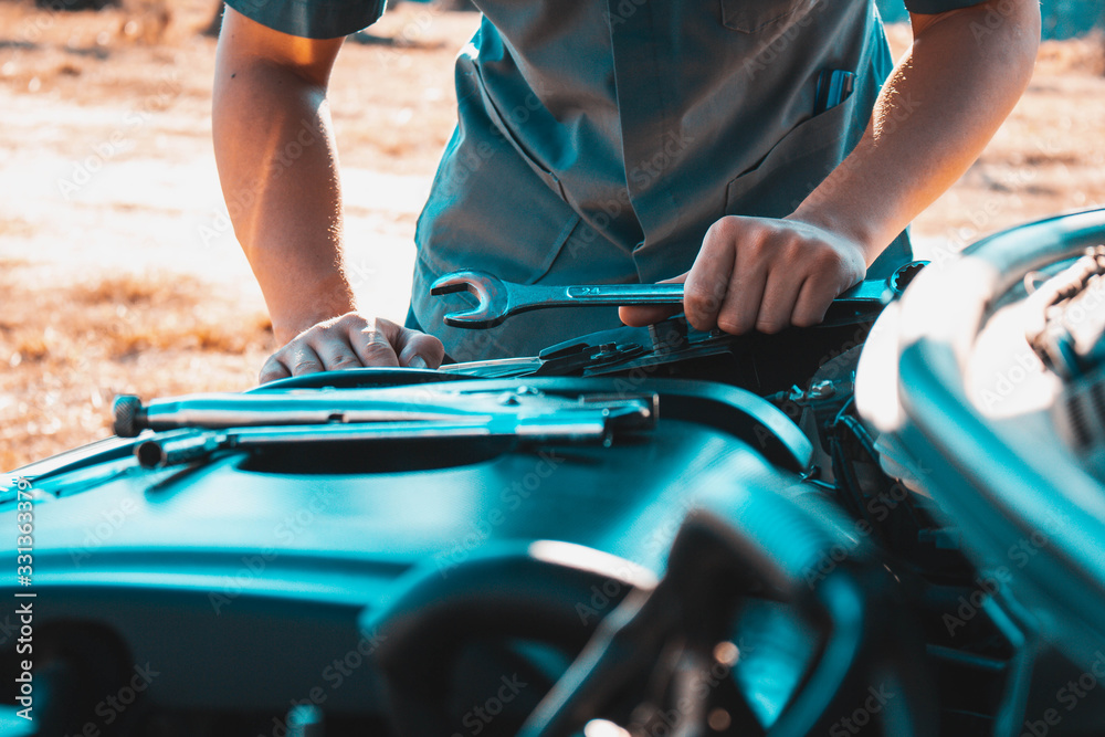 Machanic holding wrench in the repair garage,Car maintenance concept Machanic holding wrench in the repair garage,Car maintenance concept