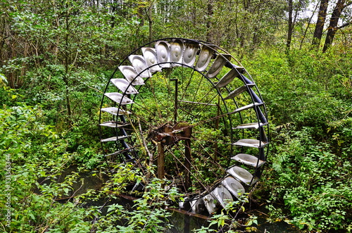 Design of water wheel with blades for water pumping. photo