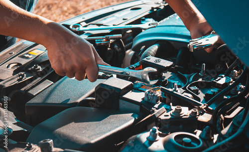 Machanic holding wrench in the repair garage,Car maintenance concept photo