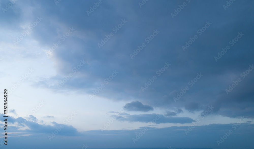 Beautiful sky with stretched clouds during twilight.