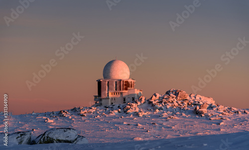 observatory dome on a mountain top at sunset