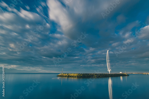 Morning photo of entrance to marina in Lausanne  Switzerland with Whirligig harbour front in the foreground  with Lac Leman in the background.