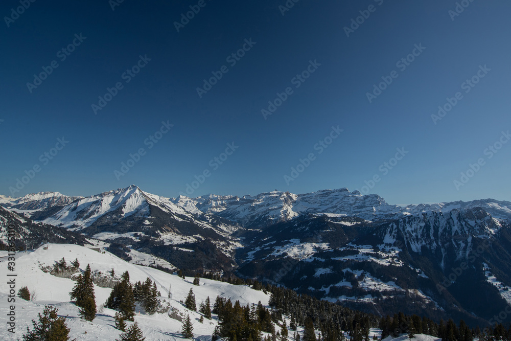 Beautiful mountain panorama from Leysin range on a cloudy winter day. Looking towards Les Diablerets ski centre and valley below.