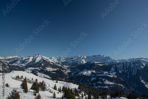 Beautiful mountain panorama from Leysin range on a cloudy winter day. Looking towards Les Diablerets ski centre and valley below. © Anze